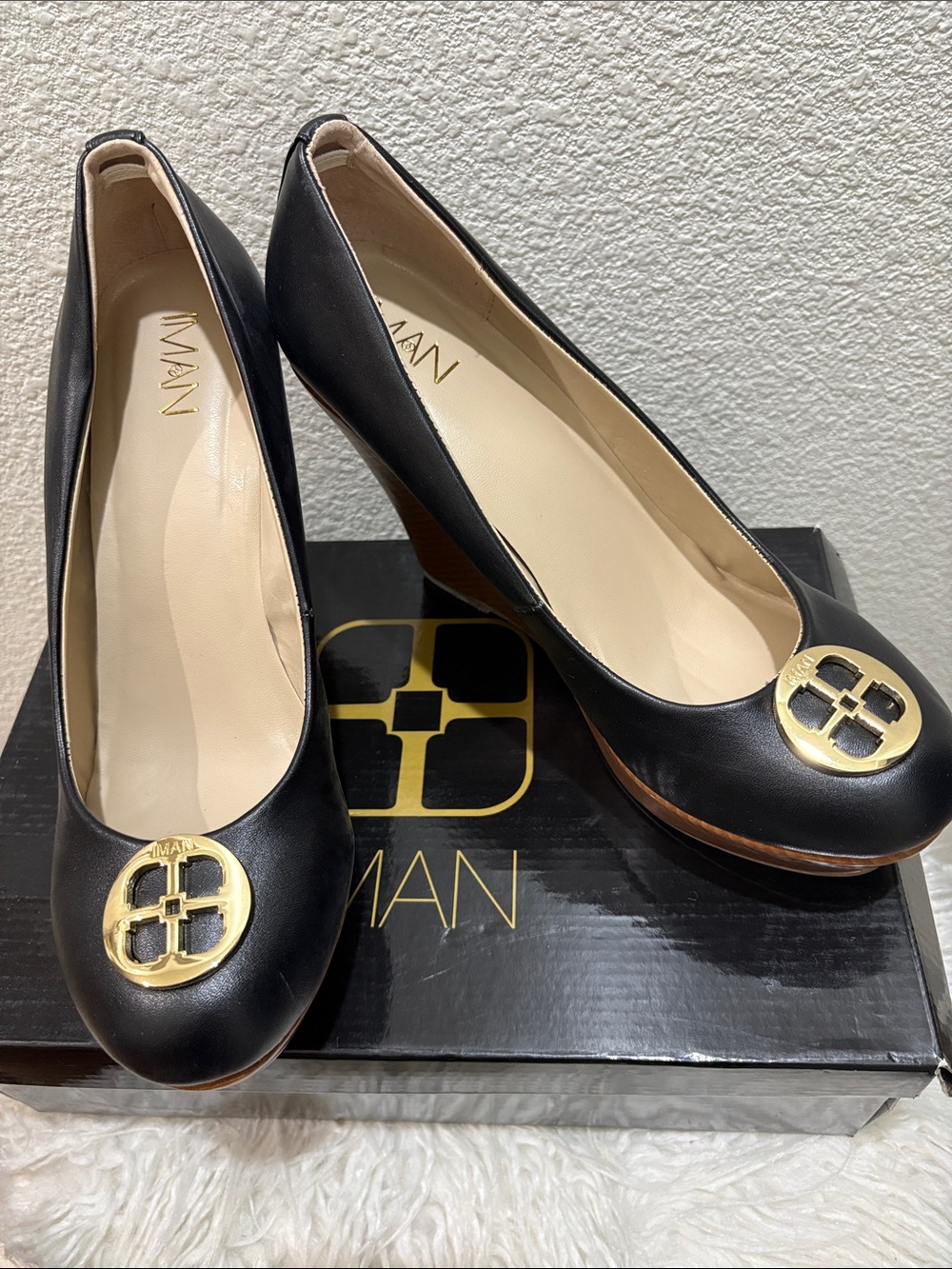 IMAN Black Leather Round-Toe Pumps with Gold Medallion